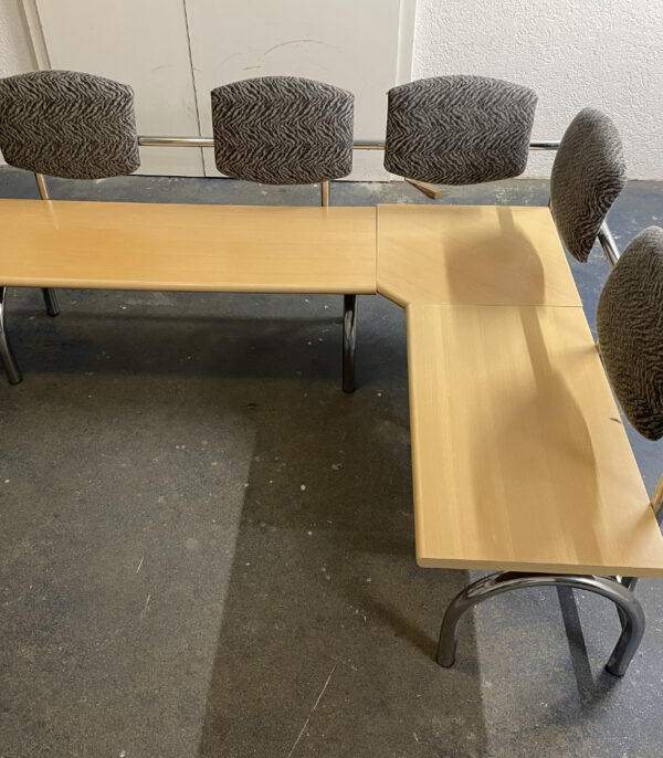 L-förmige Sitzbank mit gepolsterten Lehnen – stabile Metallkonstruktion und helle Holzsitzflächen