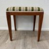 Vintage Polsterhocker mit grün geblümtem Stoffbezug